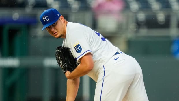 May 19, 2021; Kansas City, Missouri, USA; Kansas City Royals starting pitcher Brad Keller (56) checks the runner at first base during the third inning against the Milwaukee Brewers at Kauffman Stadium. Mandatory Credit: Jay Biggerstaff-USA TODAY Sports